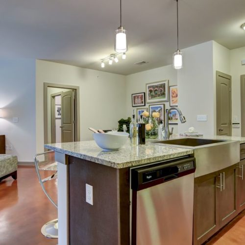 Model apartment kitchen with island and dishwasher