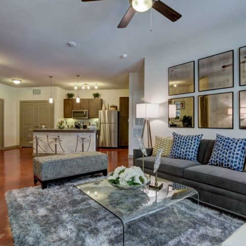 Alternate view of model apartment living room and kitchen with island