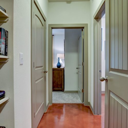 Model apartment hallway with built-in bookshelves