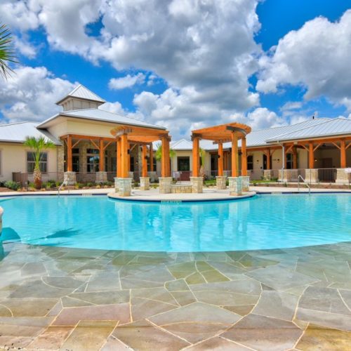 Exterior of clubhouse, outdoor pool and patio with fire pit